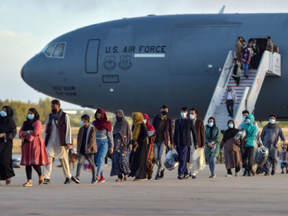 Refugees disembark from a US air force aircraft after an evacuation flight from Kabul at t