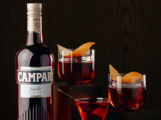campari bottle and three red coctails