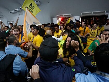 Security personnel clash with indigenous people and students as they storm the venue durin