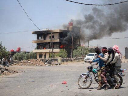 Tribal and bedouin fighters cross Walga town as they mobilise amid clashes with Druze gunm