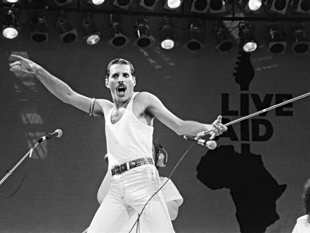 Live Aid. Wembley, London, England. Freddie Mercury leads his band Queen in a storming set