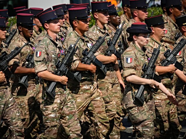 Polish armoured vehicles and soldiers march thourgh the city during the annual military pa