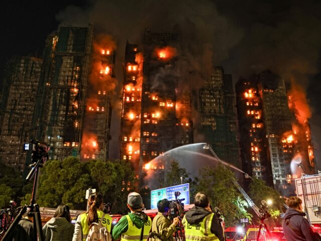 Firefighters tackle a fire engulfing residential buildings at Wang Fuk Court in the Tai Po