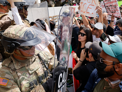 ice-protests-getty Los Angeles, CA - June 14: Marines push back anti-ICE protesters in front of the Federal B