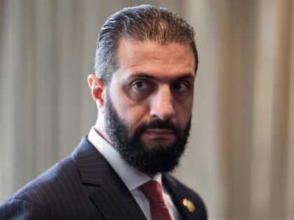 Syrian President Ahmed al-Sharaa waits to meet with France's President Emmanuel Macron on