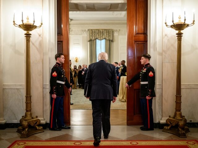 President Donald Trump enters the State Dining Room to deliver remarks to a group of recen