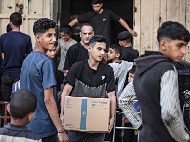 un food programme DEIR AL BALAH, GAZA - OCTOBER 13: Palestinians carry packages of food and humanitarian aid
