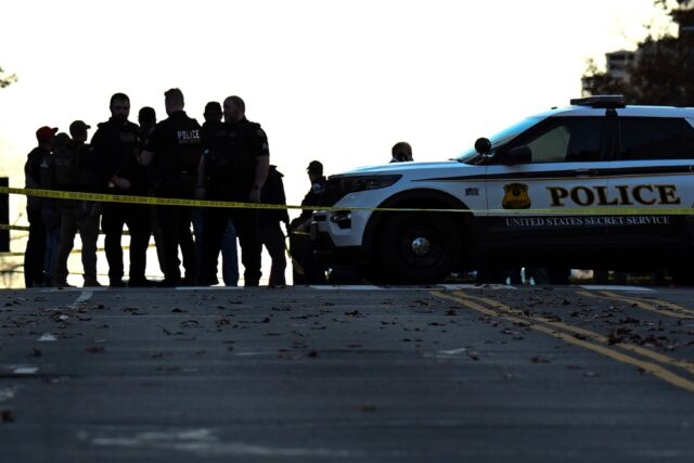 Law-enforcement officials visit the crime scene of a shooting in downtown Washington, DC,