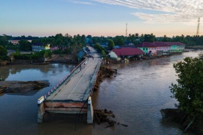A bridge damaged by flash floods is seen during sunrise in Meureudu, Pidie Jaya district i