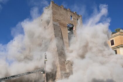 Dust rises after the collapse of part of the medieval Torre dei Conti tower in Rome
