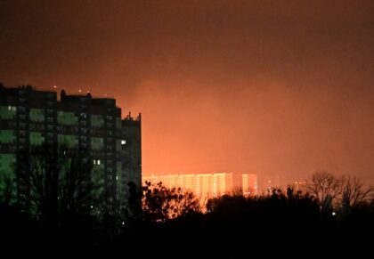 The glow from explosions during a drone and missile strikes in Kyiv on November 14, 2025,