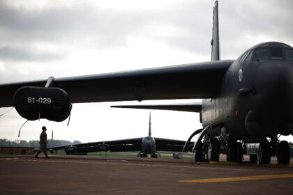 A member of a US Air Force flight crew walks under a wing of a B-52 Stratofortress bomber