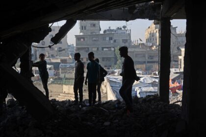 Palestinians inspected the debris of a damaged building in the Zeitoun neighbourhood of Ga