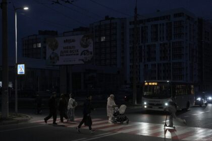 Pedestrians cross a street without lights in Chernigiv on October 22, 2025, following a re