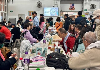 Residents take refuge in a temporary shelter in Hong Kong's Tai Po district after a d