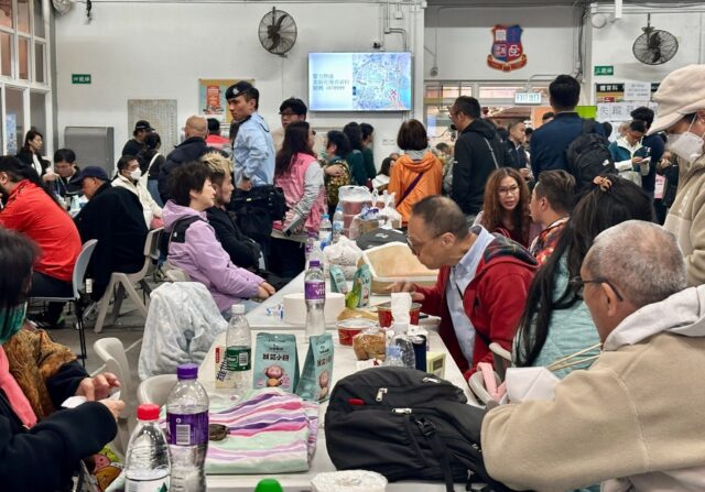 Residents take refuge in a temporary shelter in Hong Kong's Tai Po district after a d