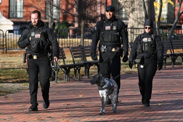 Secret Service officers patrol across from the White House, in Washington, DC on November