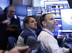 Dow posts record high; Nasdaq drops amid tech worries