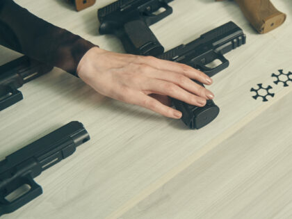 woman's hand reaching for gun