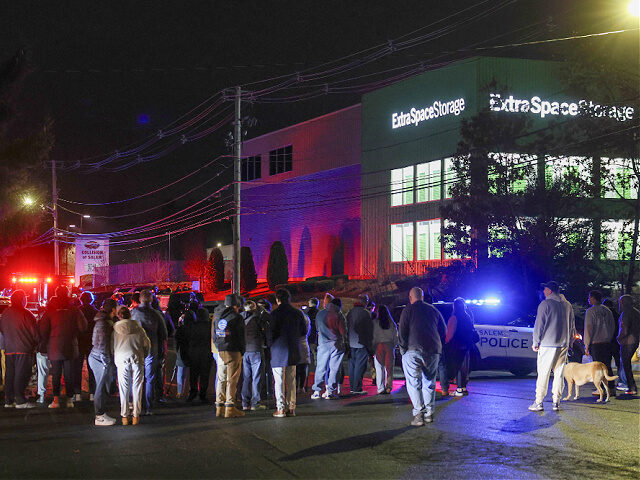 12182025-brown-university-shooting-suspect-found-nh-ap People gather outside a storage facility where a suspect in the shooting at Brown Universi