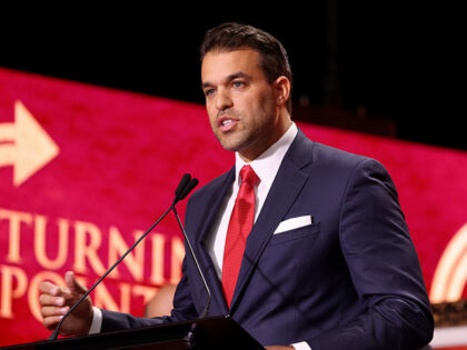 Andrew Kolvet speaking with attendees at the Memorial for Charlie Kirk at State Farm Stadi