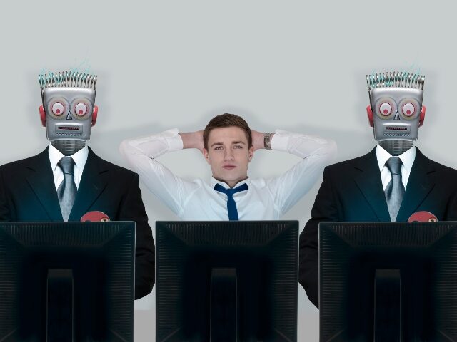 A human worker with his AI replacements