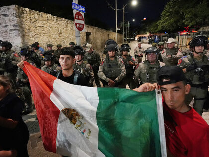 Anti ICE protesters gather near the Alamo as Texas state troopers keep watch in downtown S