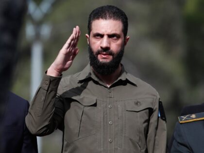 Syria's interim president, Ahmad al-Sharaa, salutes during celebrations marking the f