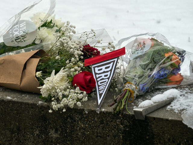 Flowers and candles are seen at a makeshift memorial outside the Barus & Holley engine