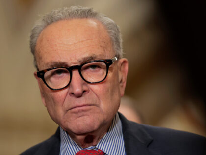U.S. Senate Minority Leader Chuck Schumer (D-NY) looks on as senators speak to reporters f
