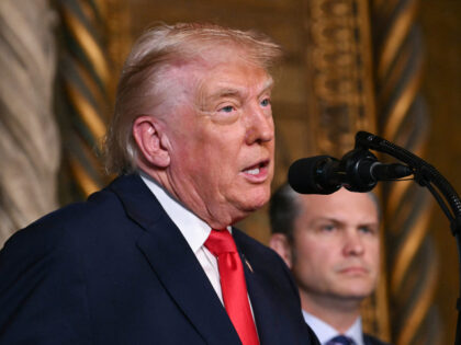 US Secretary of Defense Pete Hegseth (R) listens to US President Donald Trump announcing t