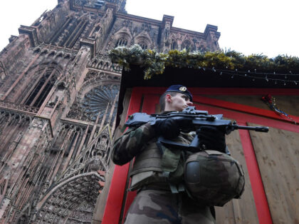 TOPSHOT - A French soldier stands guard at the Christmas market in front of the Cathedral,