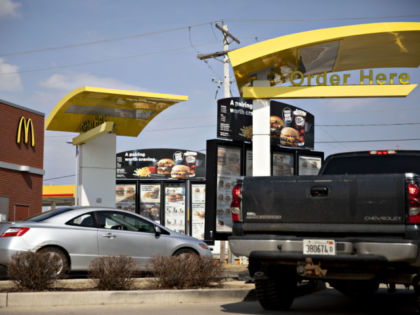 Vehicles sit in drive-thru lanes at a McDonald's Corp. restaurant in Princeton, Illinois,
