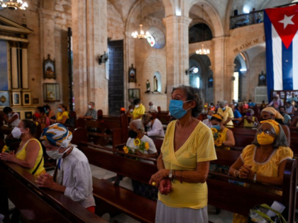 Followers of Cuba's patron saint Virgin of Charity pray to the virgin at her church in Hav