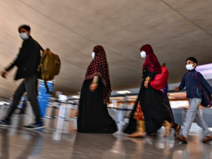 CHANTILLY, VA - AUGUST 30: Displaced Afghans walk through the terminal to an awaiting bus