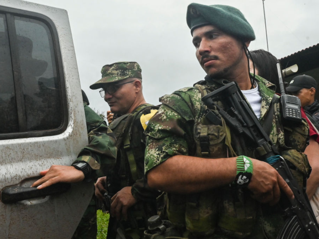 GettyImages-1251882786 FARC-EP dissidence top commander, aka Ivan Mordisco (L), is pictured before a meeting with