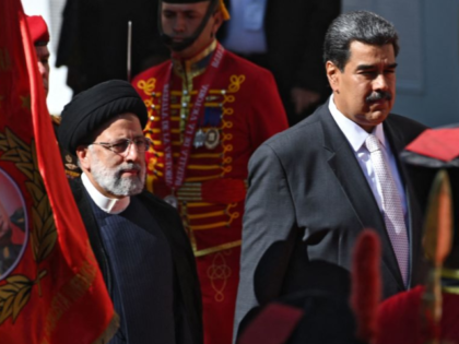 Iranian President Ebrahim Raisi (L) is welcomed by Venezuelan President Nicolas Maduro at