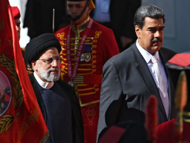 Iranian President Ebrahim Raisi (L) is welcomed by Venezuelan President Nicolas Maduro at