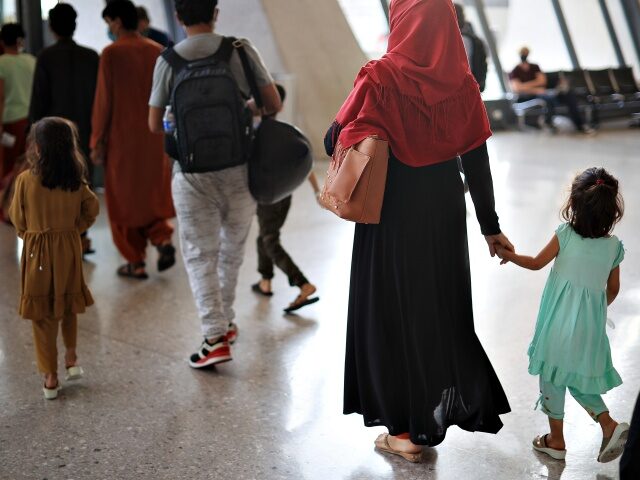 DULLES, VIRGINIA - AUGUST 27: Refugees arrive at Dulles International Airport after being