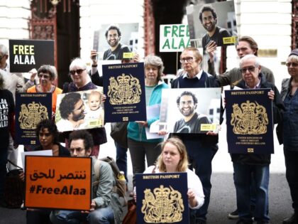 Protesters hold pictures of jailed British-Egyptian activist Alaa Abdel Fattah along with