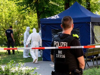 Forensic experts of the police secure evidence at the site of a crime scene in a park of B