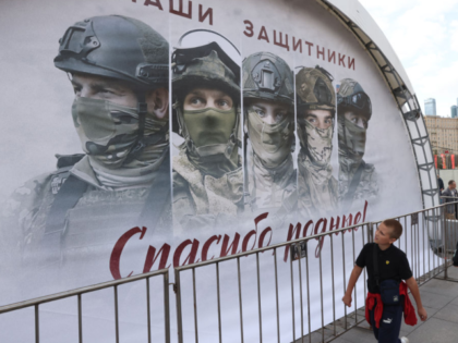 MOSCOW, RUSSIA - APRIL 28 (RUSSIA OUT) People walk past a billboards bearing images of Rus