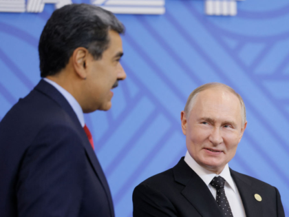 Russian President Vladimir Putin greets Venezuelan President Nicolas Maduro during an offi