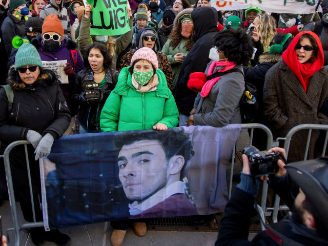 Protesters hold signs outside New York State Supreme Court in New York, US, on Friday, Feb