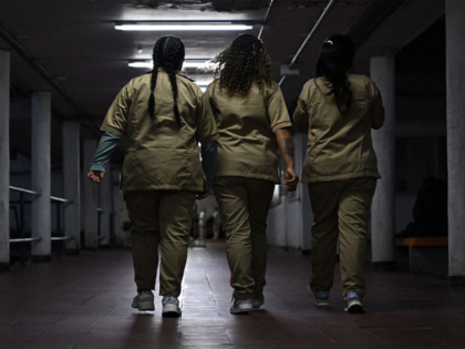 Inmates walk on a corridor at the Buen Pastor women's prison in Bogota on April 29, 2025.