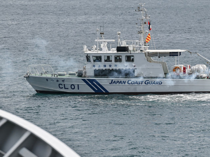 A Japan Coast Guard ship burn flares to represent an onboard fire during a maritime exerci