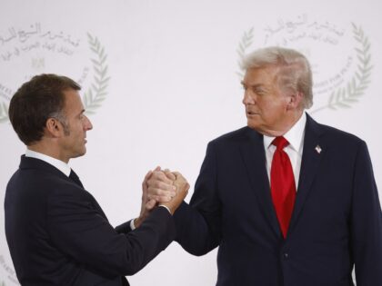 French President Emmanuel Macron (L) and US President Donald Trump (R) shake hands during