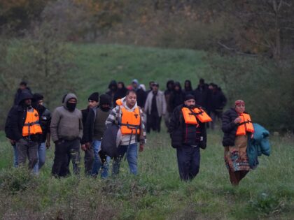 People thought to be migrants walk through Gravelines in France before an attempt to board