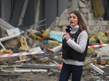 KYIV, UKRAINE - NOVEMBER 29: A journalist works at the site of a Russian airstrike on a re