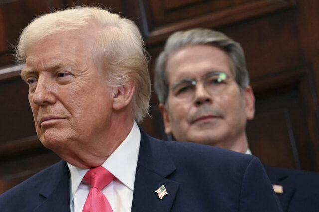 (L-R) US President Donald Trump and US Secretary of Treasury Scott Bassent, look on during